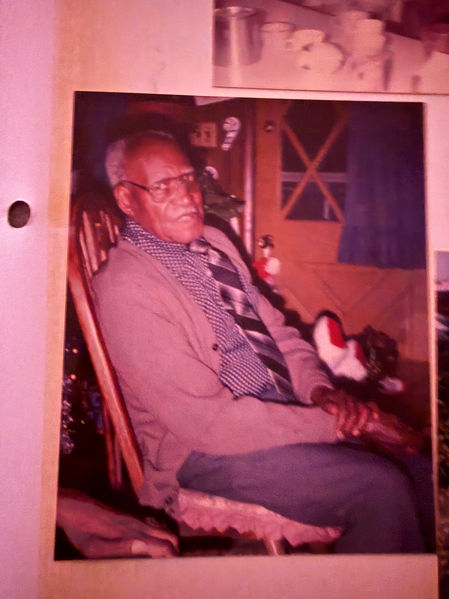 Vintage portrait of a grandfather seated by a holiday tree